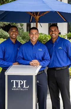 Three attendants in blue shirts at a TPL valet stand